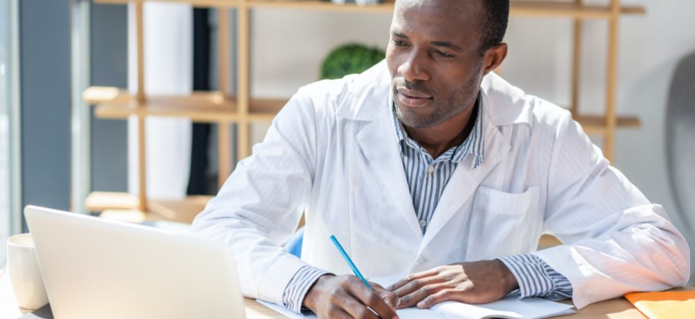 A doctor looking at his laptop